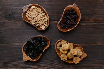 high-calorie snack, nuts and dried fruits in bowls on the table
