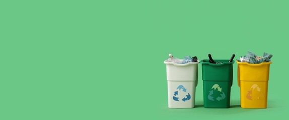 Containers with different garbage on green background with space for text. Recycling concept