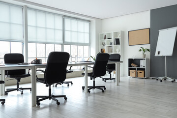 Interior of modern office with table prepared for meeting
