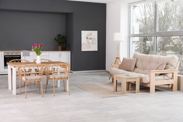 Interior of modern living room with cozy sofa and dining table