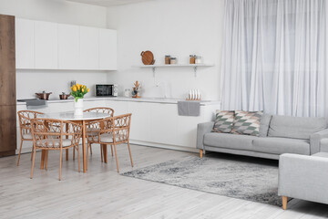 Vase with tulips on dining table in interior of modern kitchen