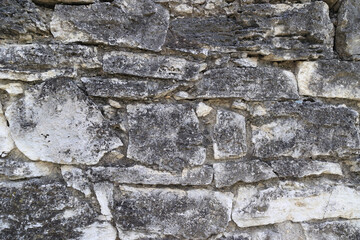 Obraz premium A Rough Stone Wall Featuring A Natural Texture And Organic Patterns.