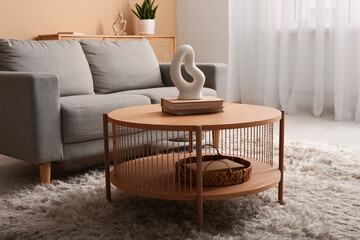 Cozy sofa with coffee table in interior of living room