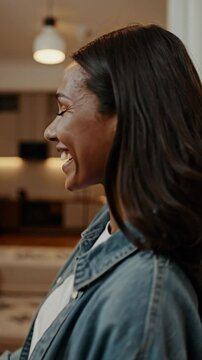 Beautiful happy woman pressing digital thermostat at home
