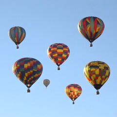 Obraz premium Colorful Hot Air Balloons Soaring High in Blue Sky