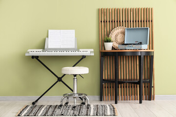 Interior of room with synthesizer, table and folding screen