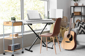 Interior of light living room with armchair, synthesizer and guitar © Pixel-Shot