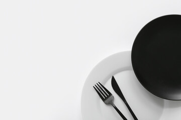 Table setting in white and black colors on light background