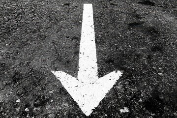 Downward arrow painted on asphalt