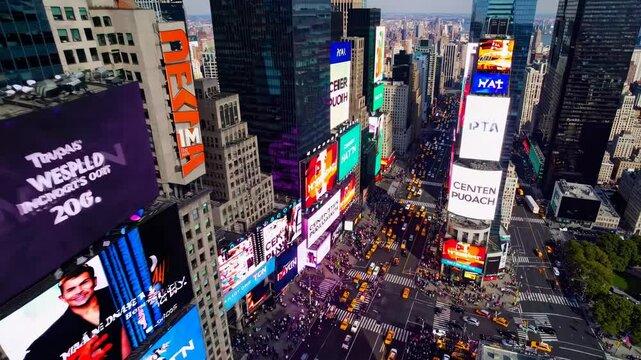 Aerial view of Times Square showcasing vibrant billboards and bustling streets. The video captures the city's dynamic energy from a high angle.