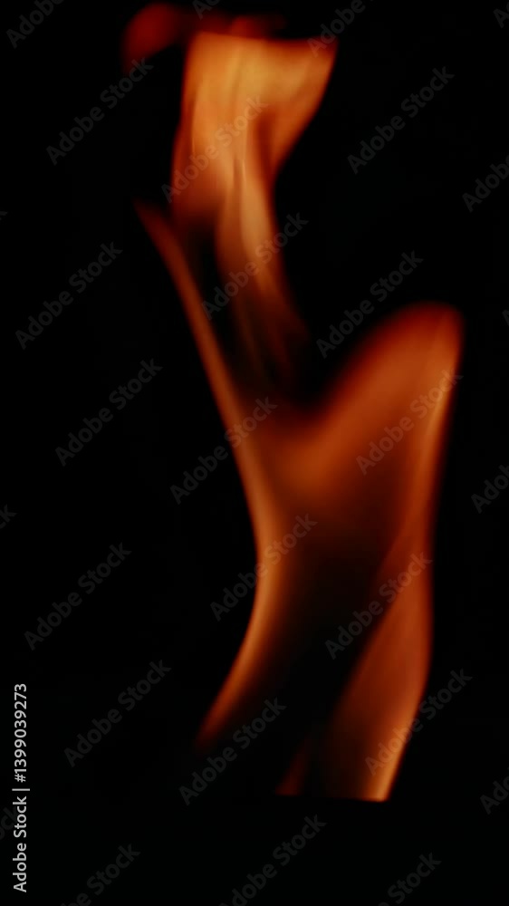 Poster close-up video of swirling flames against a dark background, captured from a low angle, creating a d