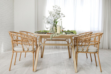 Elegant table setting with beautiful flowers and candles in light dining room