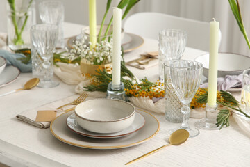 Elegant table setting with beautiful flowers and candles in restaurant, closeup