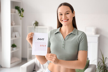 Young woman with menstrual calendar at home