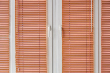 Window with closed blinds in room
