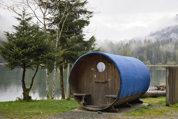 Misty mountain lake with cabins. Lush forest surrounds tranquil water, vancouver island, british colombia, canada