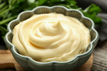 Delicious mayonnaise sauce in bowl on table, closeup
