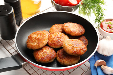 Delicious patties, spices and ketchup on table, closeup