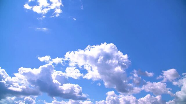 White clouds slowly float across the blue sky the bright sun shines summer timelapse 4k video footage