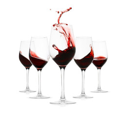 Red wine splashing in glasses on white background, set