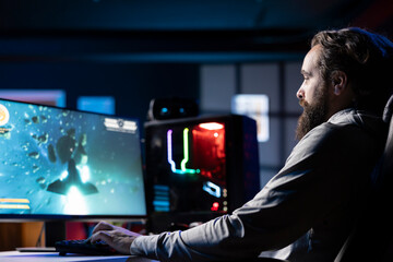 Man playing high FPS singleplayer videogame with spaceship shooting laser streams at asteroid....