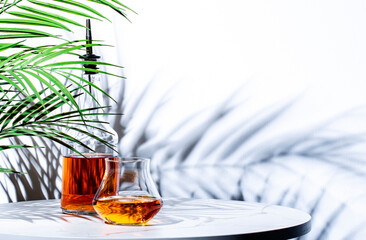 Single malt rye american bourbon whiskey n glass and bottle on white background, hard light