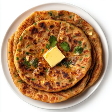 A top view of a plate of paneer paratha with butter, isolated on a white background 
