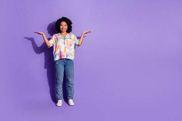 Smiling woman in colorful casual attire posing on a vibrant purple background, expressing a...
