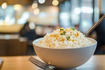 Garlic and spring onion fried rice in a white bowl.