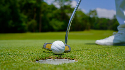 Golfer playing golf in the evening golf course, on sun set evening time.