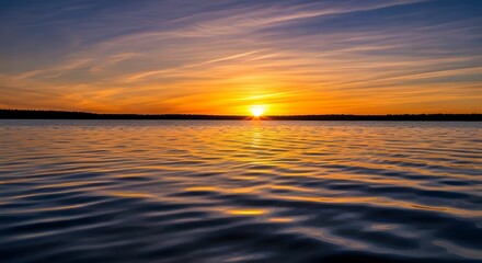 Golden sunlight painted the ocean horizon orange during the evening sunset, reflecting on the calm sea waves
