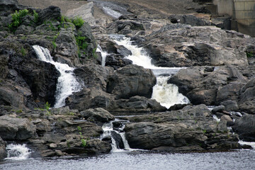 Multiple waterfalls cascading into a river. 