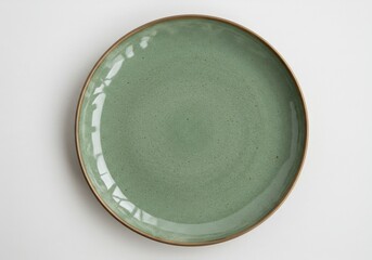 A simple studio shot of a round green ceramic plate with a brown rim on a white background surface