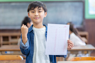 100点のテストを持つ小学生