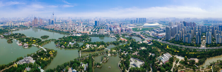 Fototapeta premium Aerial View of the Urban Landscape with River and Parks