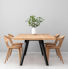 A modern dining table set with wooden chairs and a vase of greenery, set against a minimalist gray wall.