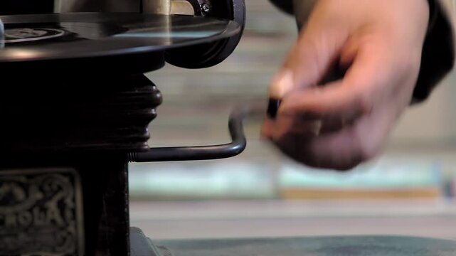 Man Turning the Crank on an Antique Phonograph - Close-Up - 4K