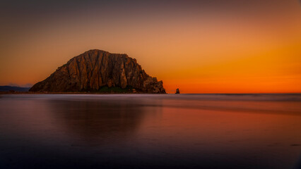 As the sun began its descent at Morro Bay California, it was casting a warm, golden hue across the landscape. Morro Bay came alive with the breathtaking spectacle of a beautiful sunset.