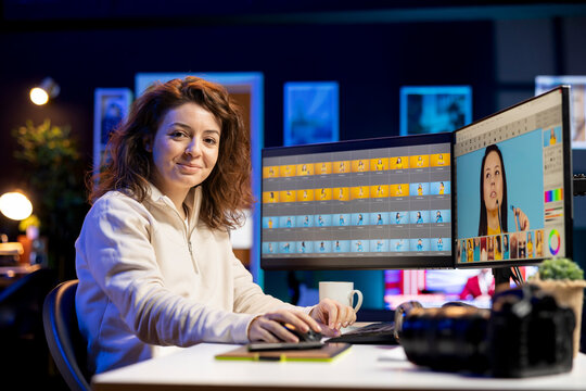 Portrait of happy photo editor browsing through images to determine the most appropriate visuals for publication in magazines. Smiling photographer manipulating images in creative studio