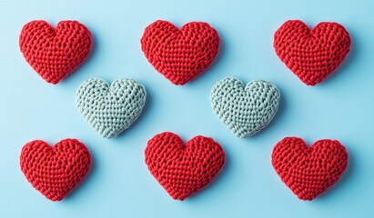 A vibrant arrangement of red paper hearts on a blue background. showcasing a creative craft display ideal for Valentine's Day decorations or romantic themes