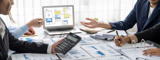 Business intelligence and data analysis concept. Analyst team working on financial data analysis dashboard on laptop screen as marketing indication for effective business strategic planning. Insight