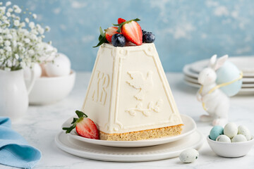 Vanilla cottage cheese paskha on biscuit decorated with strawberries and blueberries. Traditional...