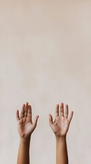 Two hands are raised in the air