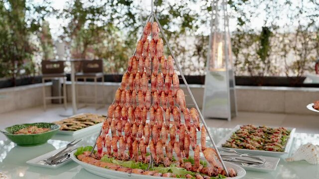 close up of pyramid shrimp tower at seafood buffet in refined indoor event setting
