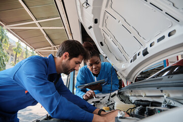 EV car check, mechanic workers coworker inspects and maintains service of electric engine and...