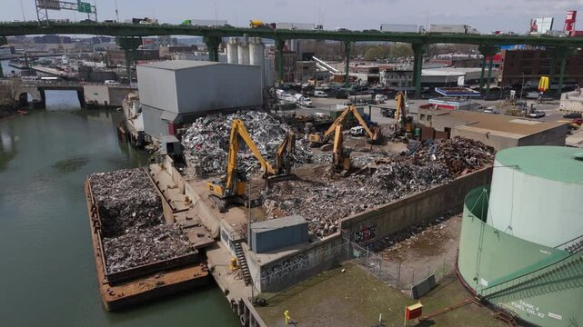 wider flying clockwise around metal scrapyard in Brooklyn