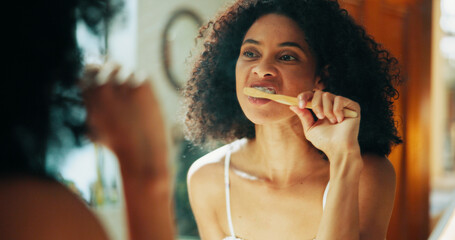 Mirror, dental care and woman with brushing teeth in bathroom for plaque removal, fresh breath and...