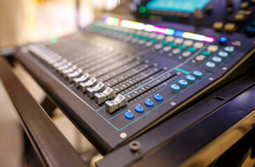 A black and white electronic instrument with a blue and green control panel