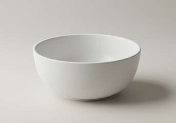 A simple white ceramic bowl centered on a plain surface with soft lighting and a subtle shadow casted