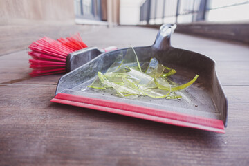 Cleaning up broken glass during afternoon chores at home